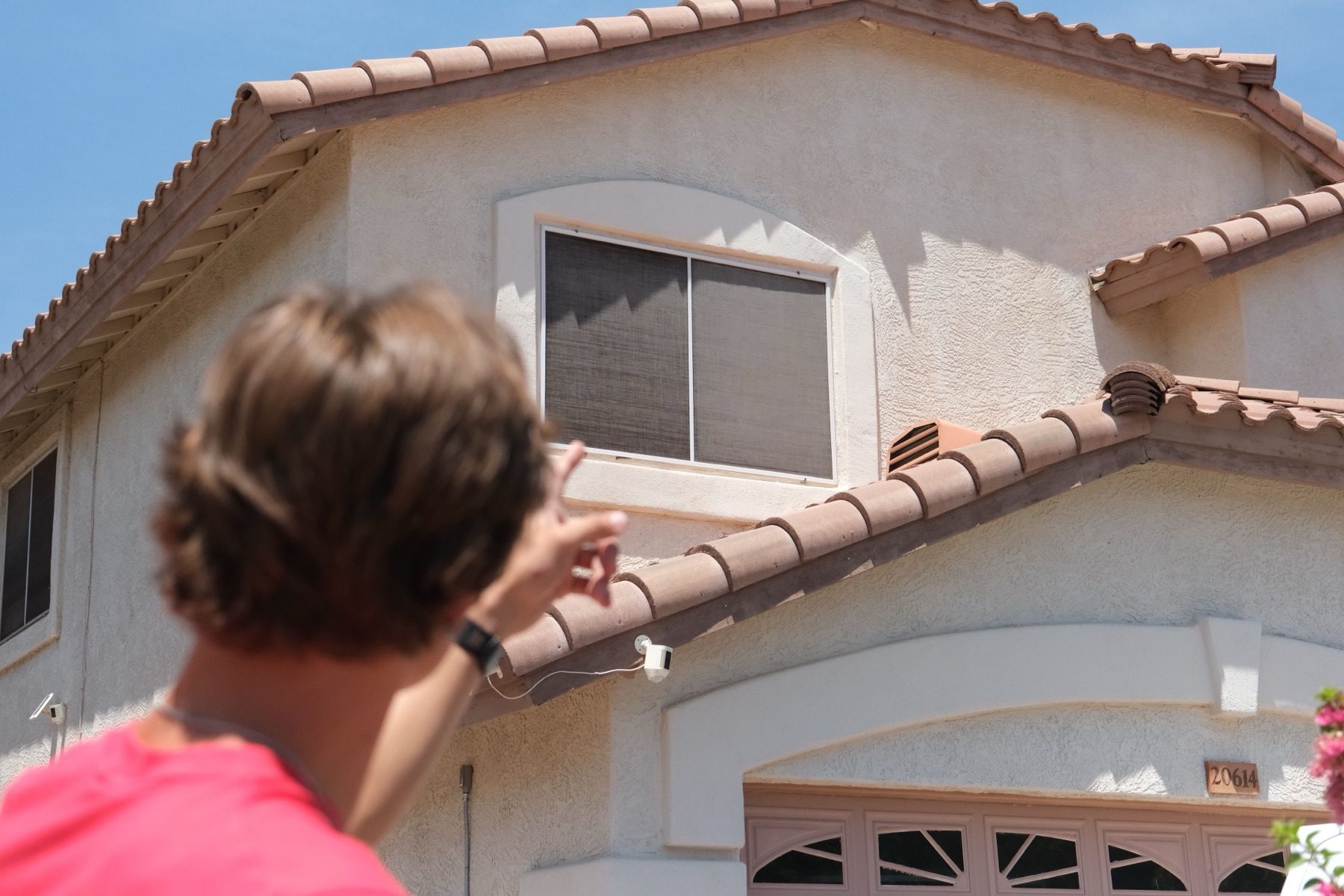 A REBEL crew member assessing a second-story screen before quoting the job