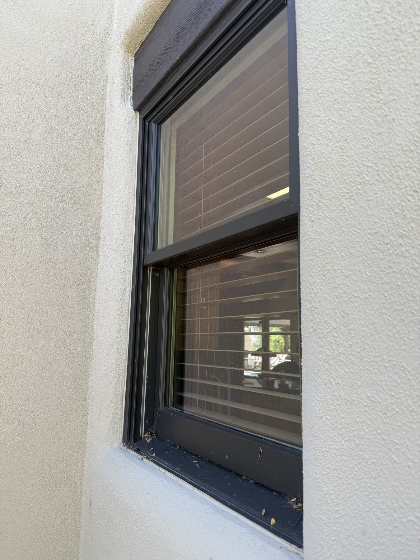 Double-hung window with dull, dirty glass before cleaning