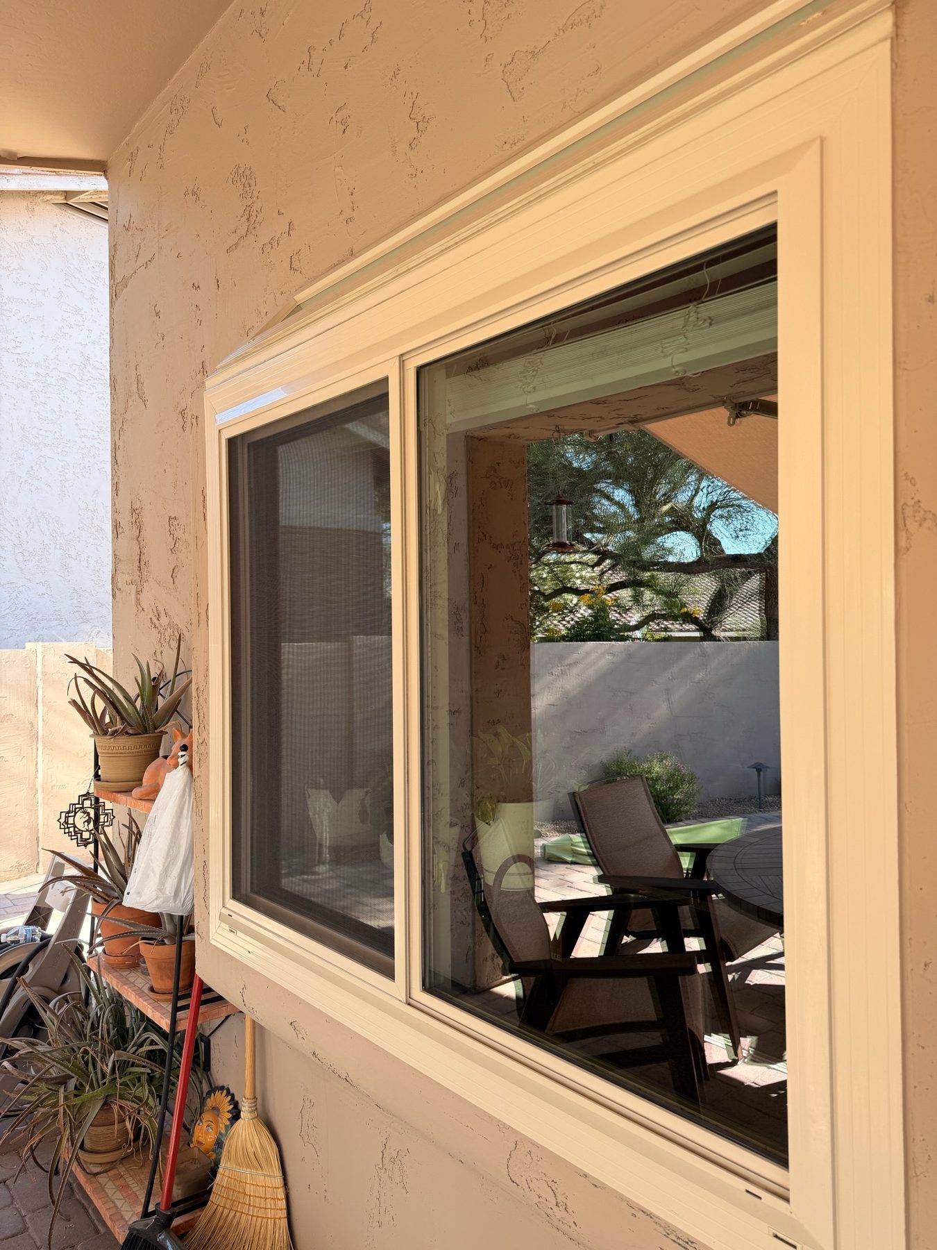 Clean patio window reflecting outdoor furniture