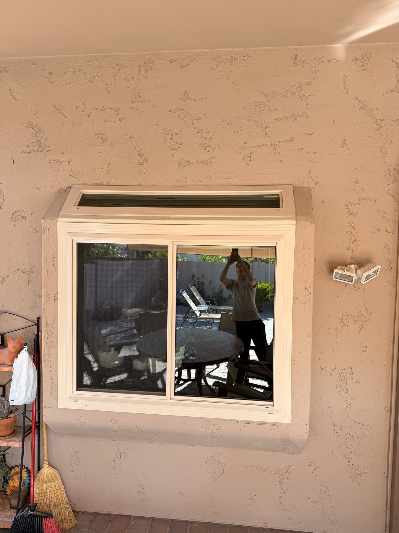 REBEL crew member cleaning a large window