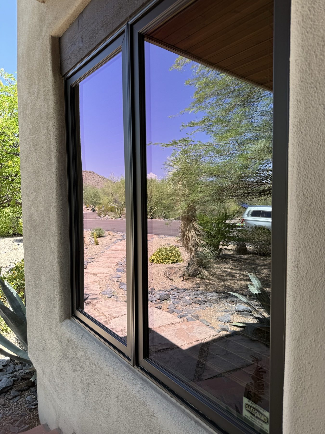 Corner windows reflecting the desert landscape after cleaning