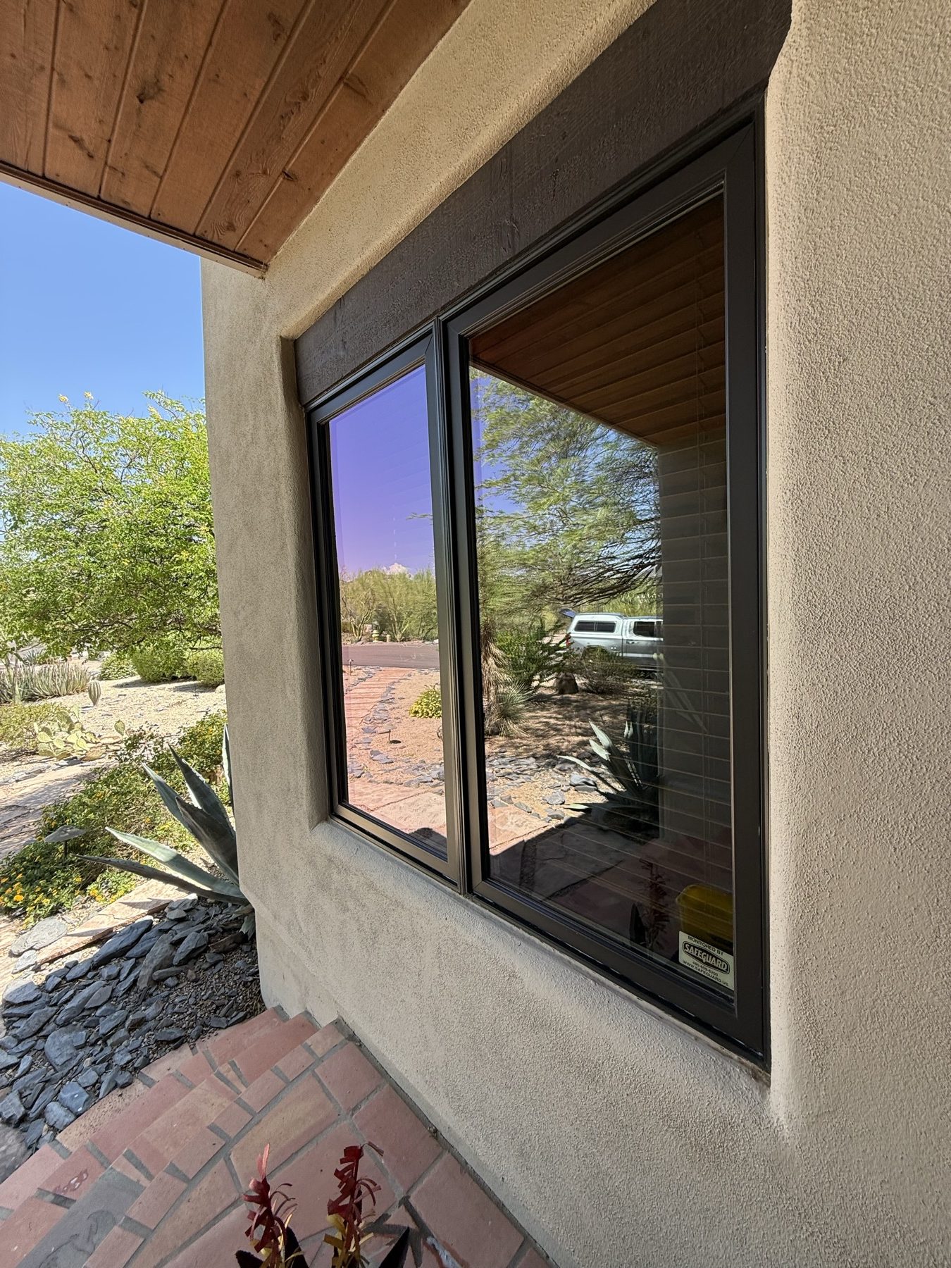 Clean corner window under a wood-beam patio ceiling